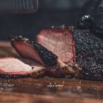 sliced meat on brown wooden chopping board